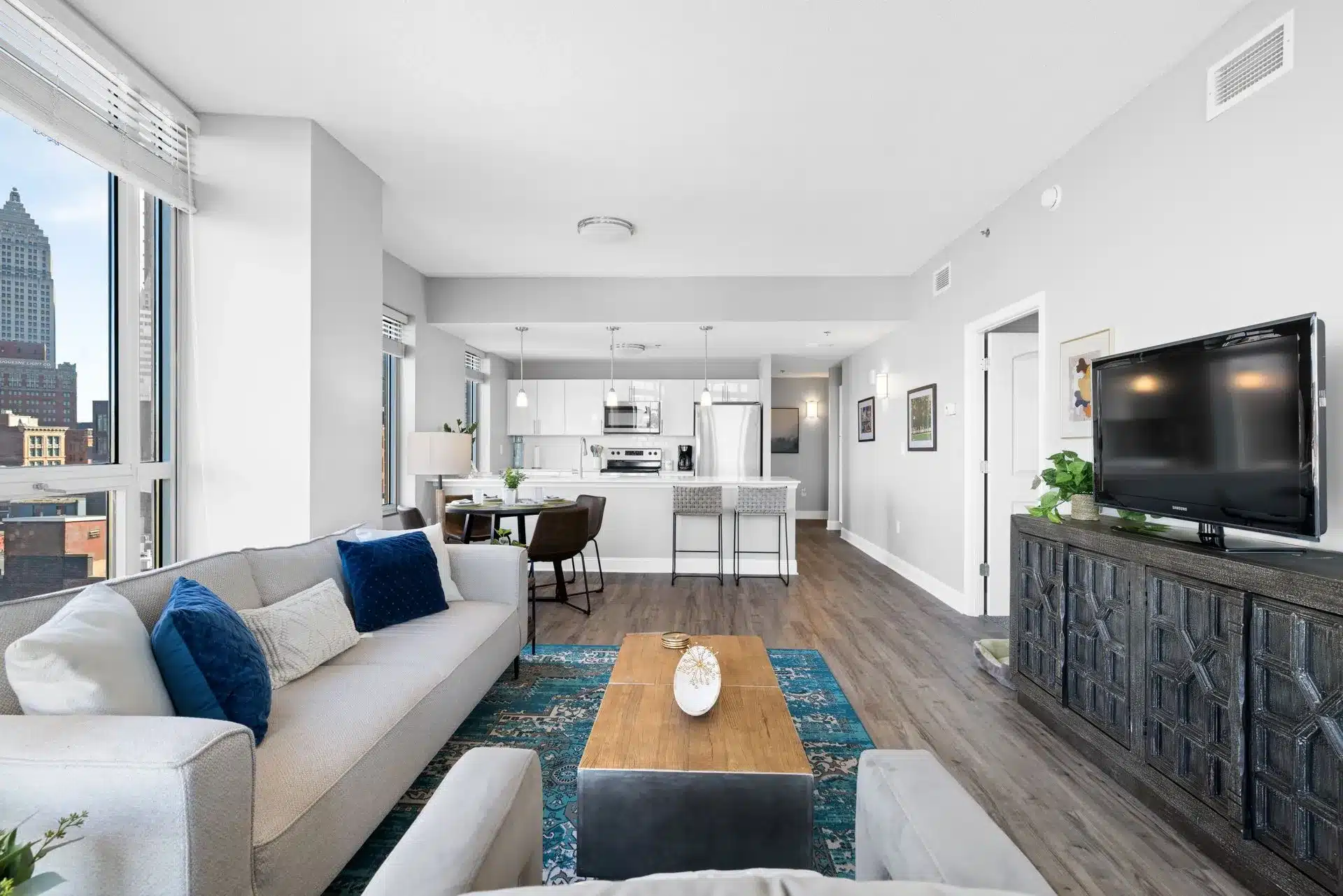 Renovated apartment kitchen with white cabinetry and modern finishes at Encore