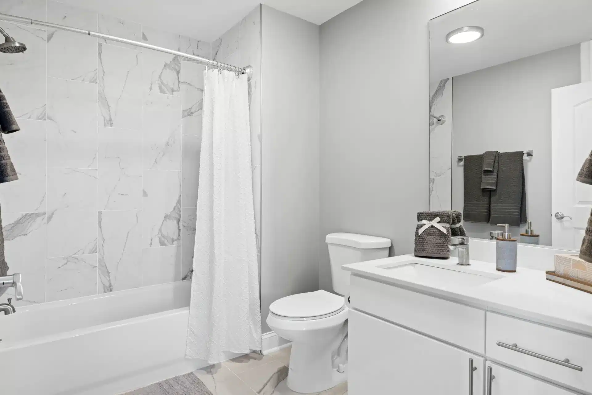 Renovated apartment bathroom with modern vanity and fixtures at Encore Pittsburgh