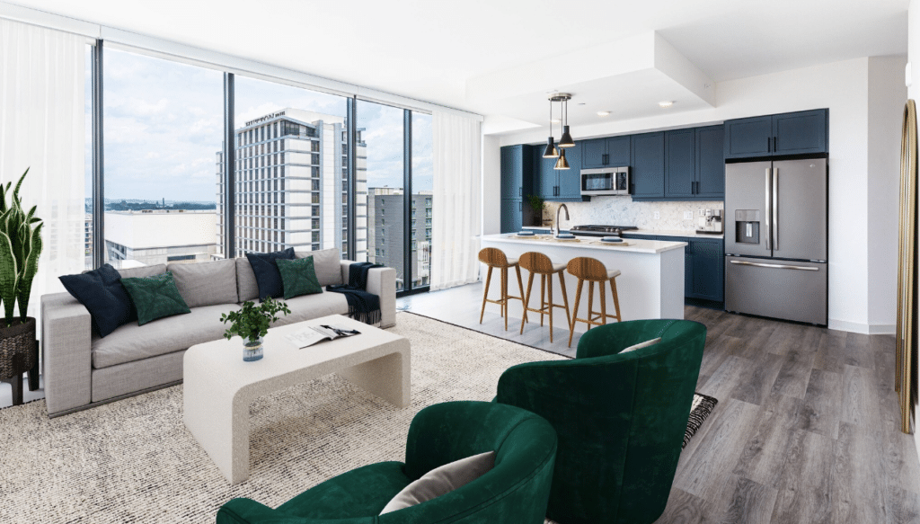 Bright apartment with navy kitchen cabinets, floor-to-ceiling windows, and open living area featuring green accent chairs and modern furnishings.