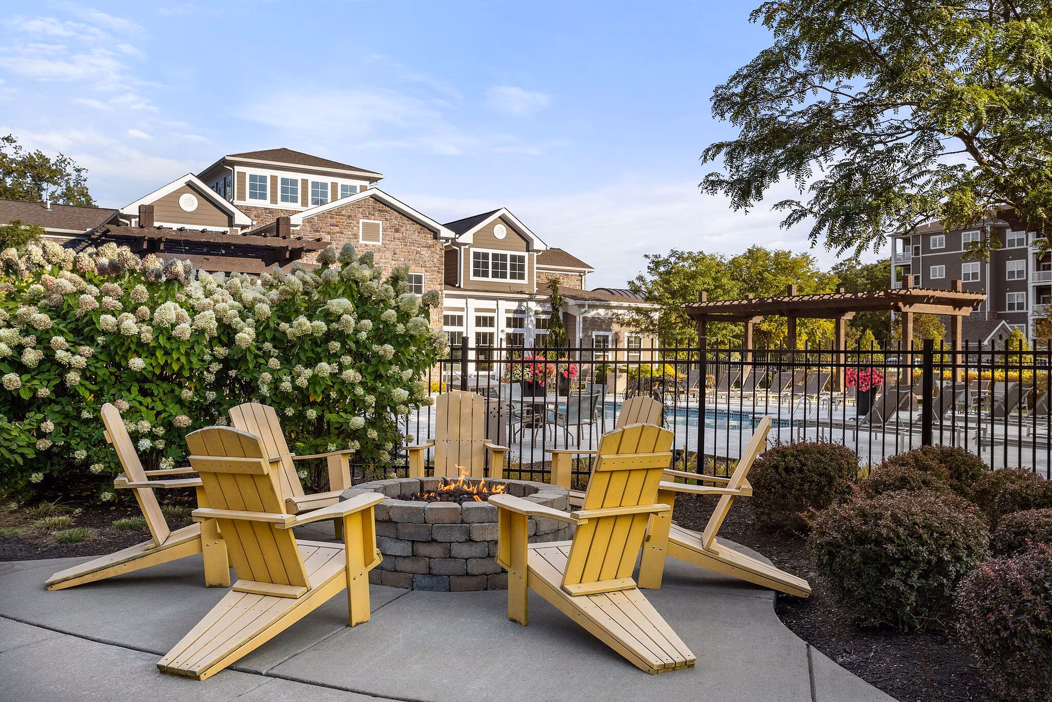 Renovated apartment outdoor seating and fire pit amenity area with modern community design