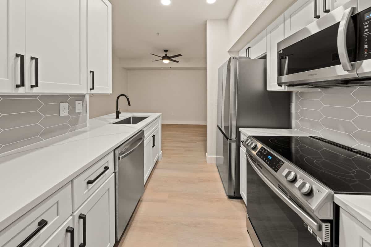 Contemporary galley kitchen renovation with modern backsplash and upgraded finishes in Phoenix, AZ