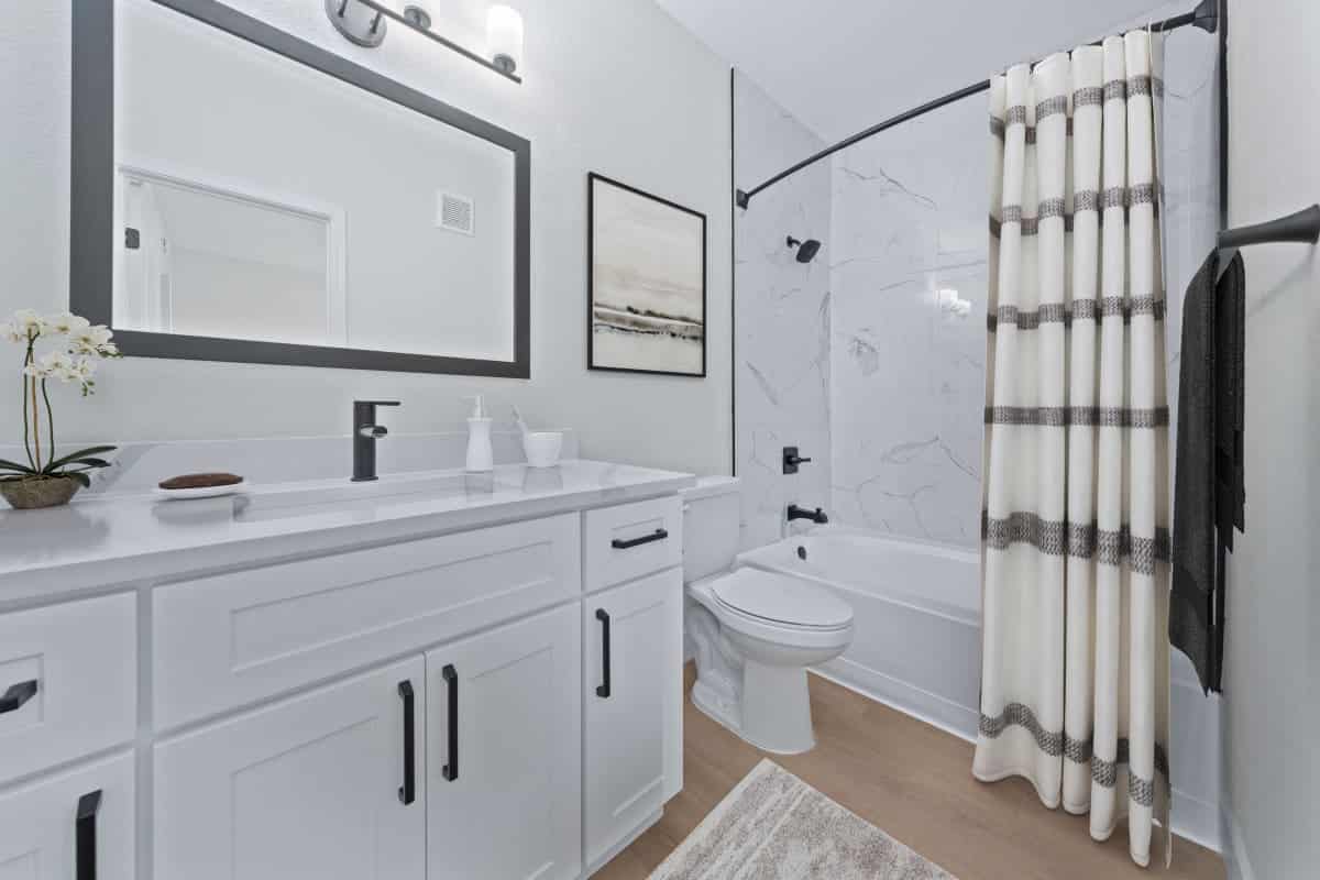 Updated apartment bathroom renovation with dual vanity and modern fixtures in Phoenix, AZ